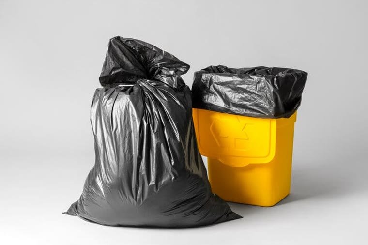 Plastic garbage bags and bin